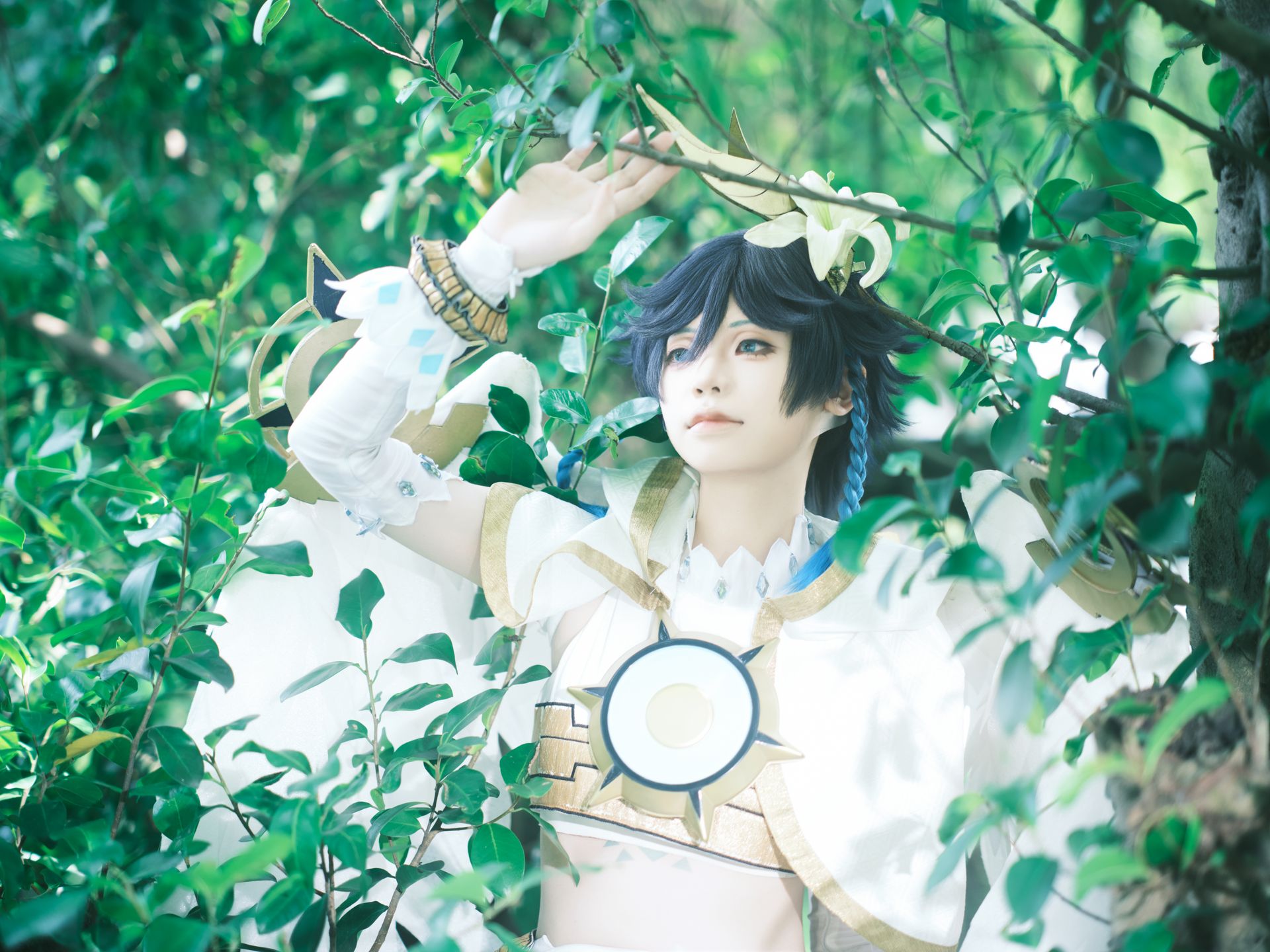 Cosplayer in fantasy costume poses among lush leaves, embodying a mythical character.