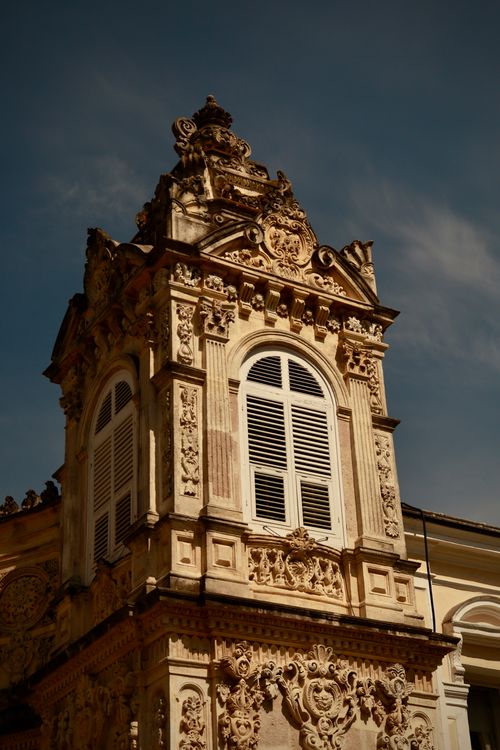 Free Close-up of an ornate historic building facade under a clear sky. Stock Photo