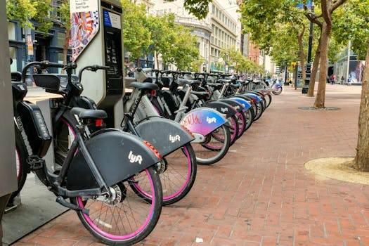 Row of rental bicycles lined up in a San Francisco street, available for public use.