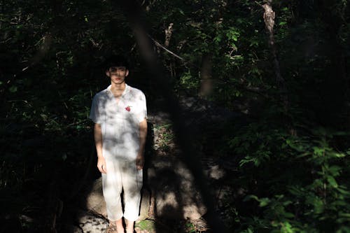 Man in White Shirt and White Pants Standing