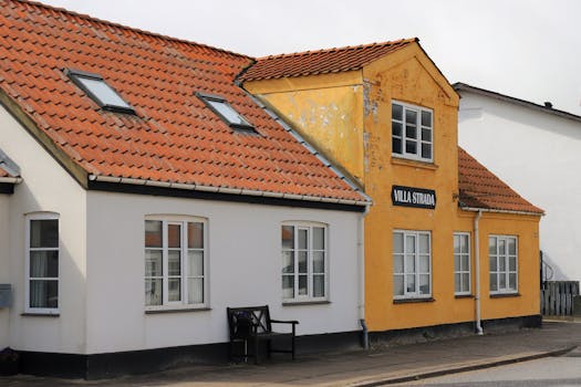 A colorful house in Løkken, Denmark, showcasing traditional Nordic architecture under a sunny sky.
