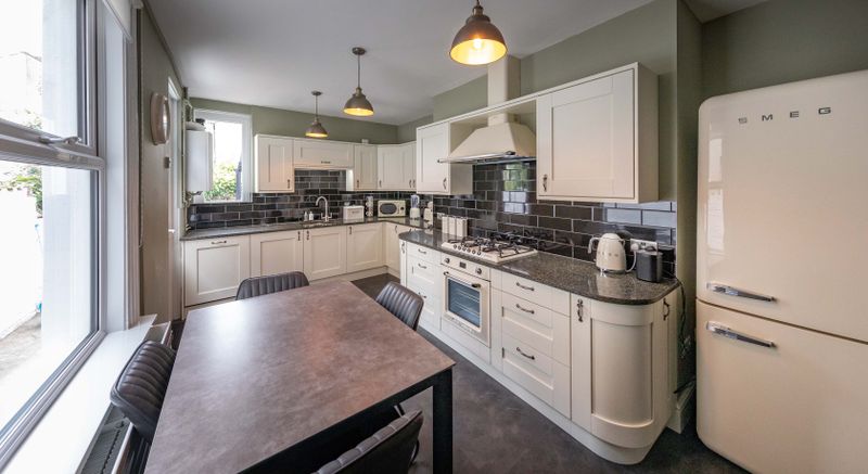 Spacious modern kitchen with white cabinetry