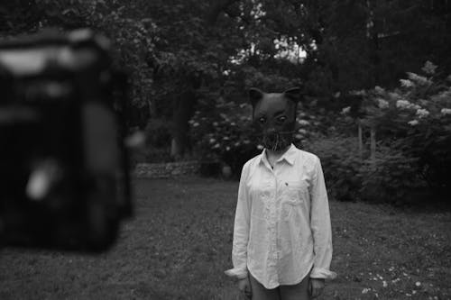 Grayscale Photo of Person Wearing Cat Mask