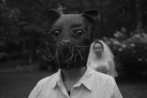 Grayscale Photo of Person Wearing Dog Mask