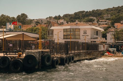 Free Scenic view of Kınalıada ferry station surrounded by water and buildings under a sunny sky. Stock Photo