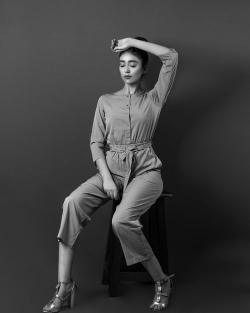 Free Stylish woman posing on a stool in black and white fashion portrait. Stock Photo