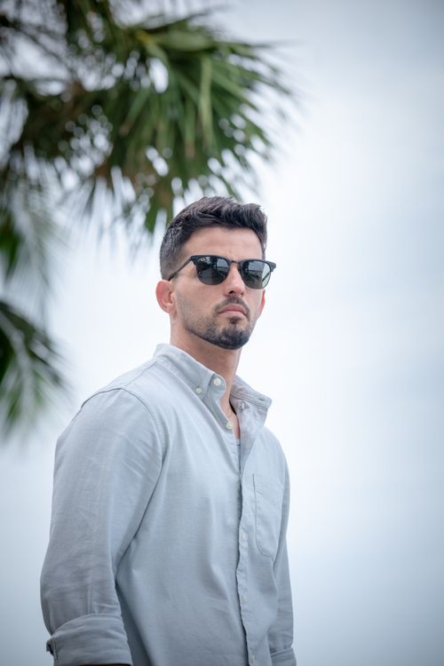 Casual Portrait of Man Under Palm Tree · Free Stock Photo