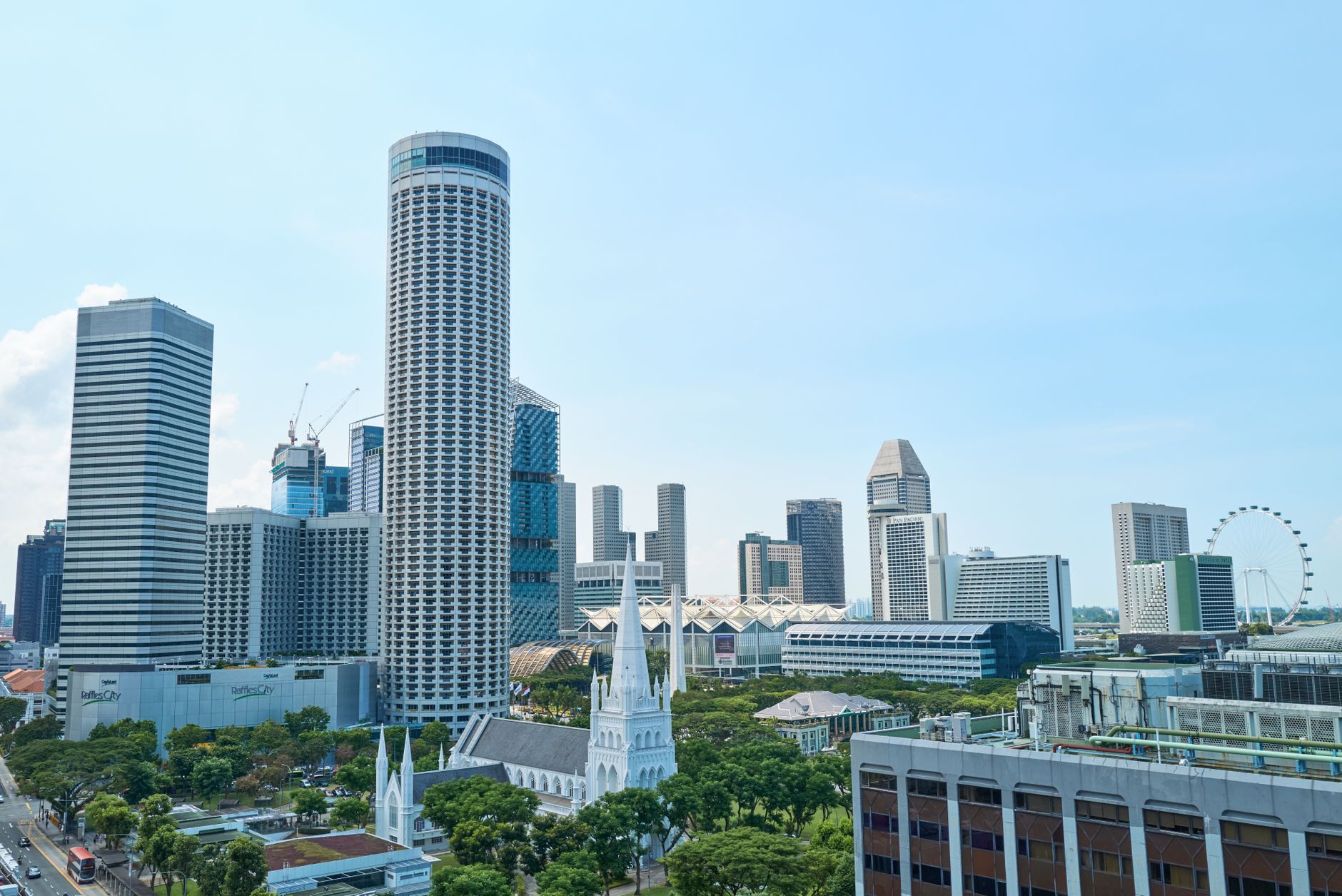 View of Singapore's modern skyline featuring iconic architecture and lush greenery, captured on a sunny day.