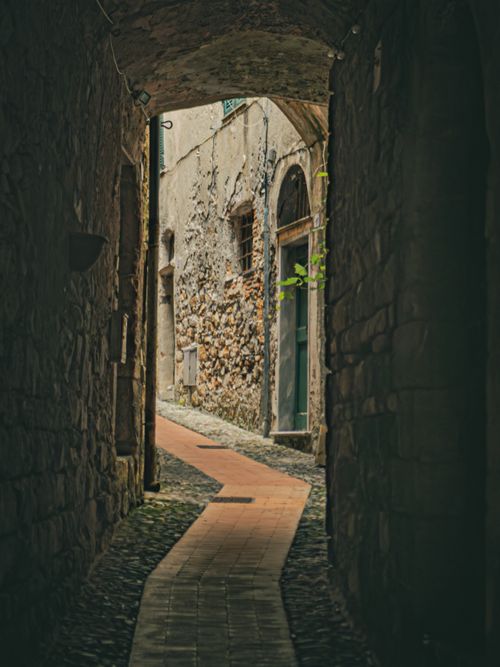 Free Explore a charming stone alleyway in a historic European village, rich in texture and ambiance. Stock Photo