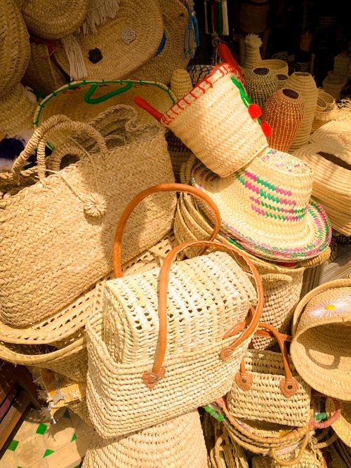 Free Colorful display of Moroccan straw bags and hats in a Rabat market. Stock Photo
