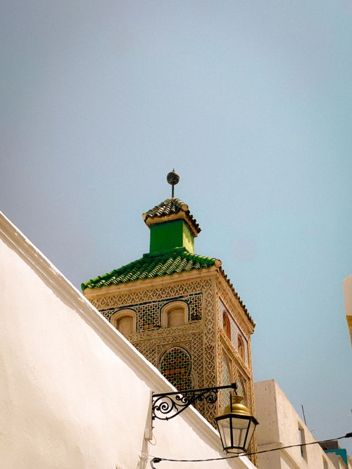 Free Beautiful Moroccan tower with intricate details and vibrant green tiles in Rabat, Morocco. Stock Photo