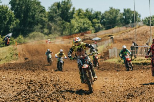 Free Thrilling motocross race on a sunny day in Mothern, France, capturing high-speed action. Stock Photo