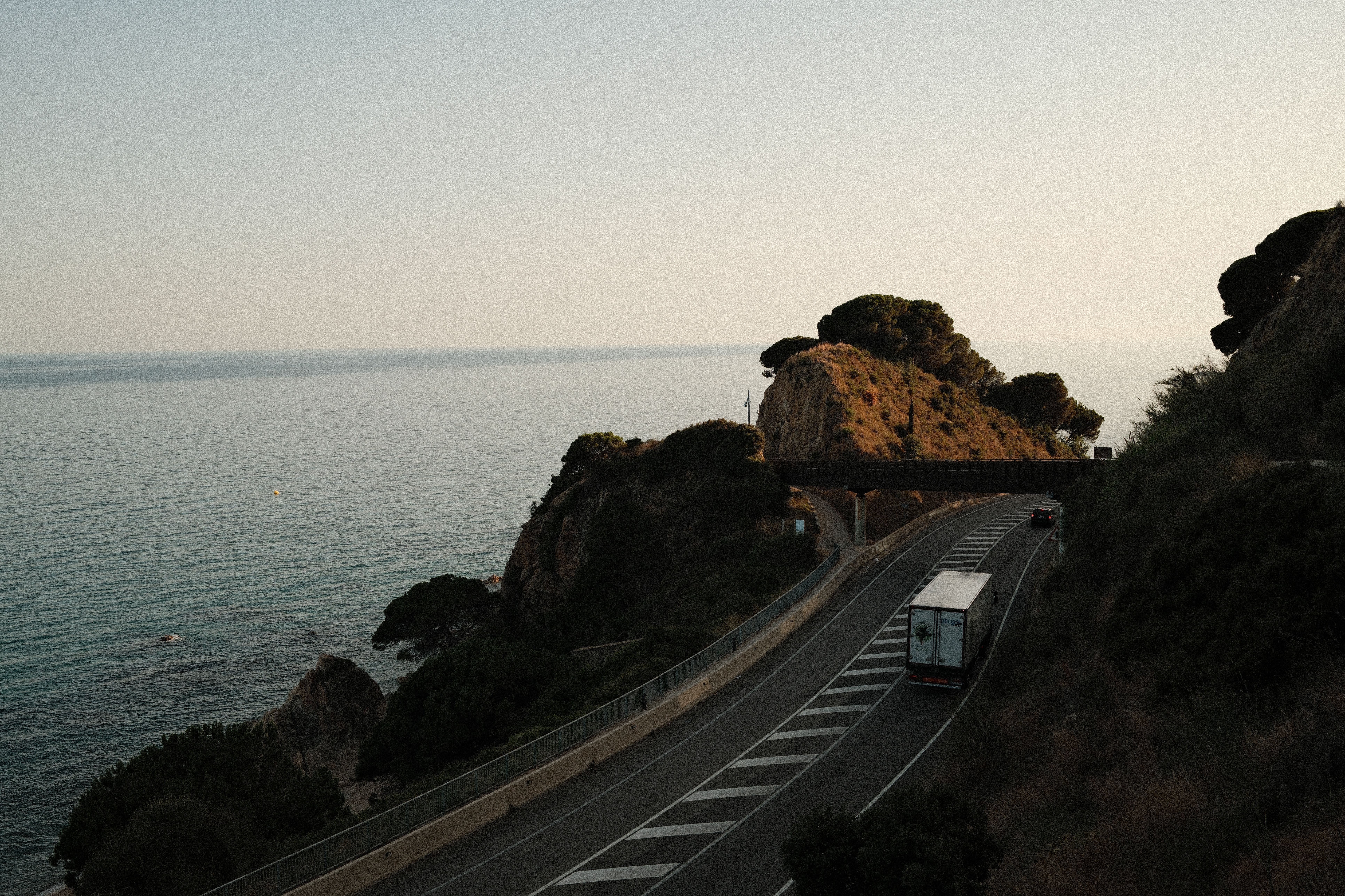 Scenic Coastal Road at Sunset with Ocean View · Free Stock Photo