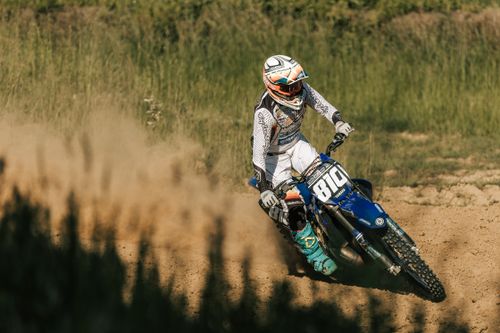 Free A skilled motocross rider performs on a dirt track in Mothern, Grand Est, France, showcasing agility and speed. Stock Photo