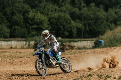 Free A motocross rider speeds through a dusty track in Mothern, Grand Est, France. Stock Photo