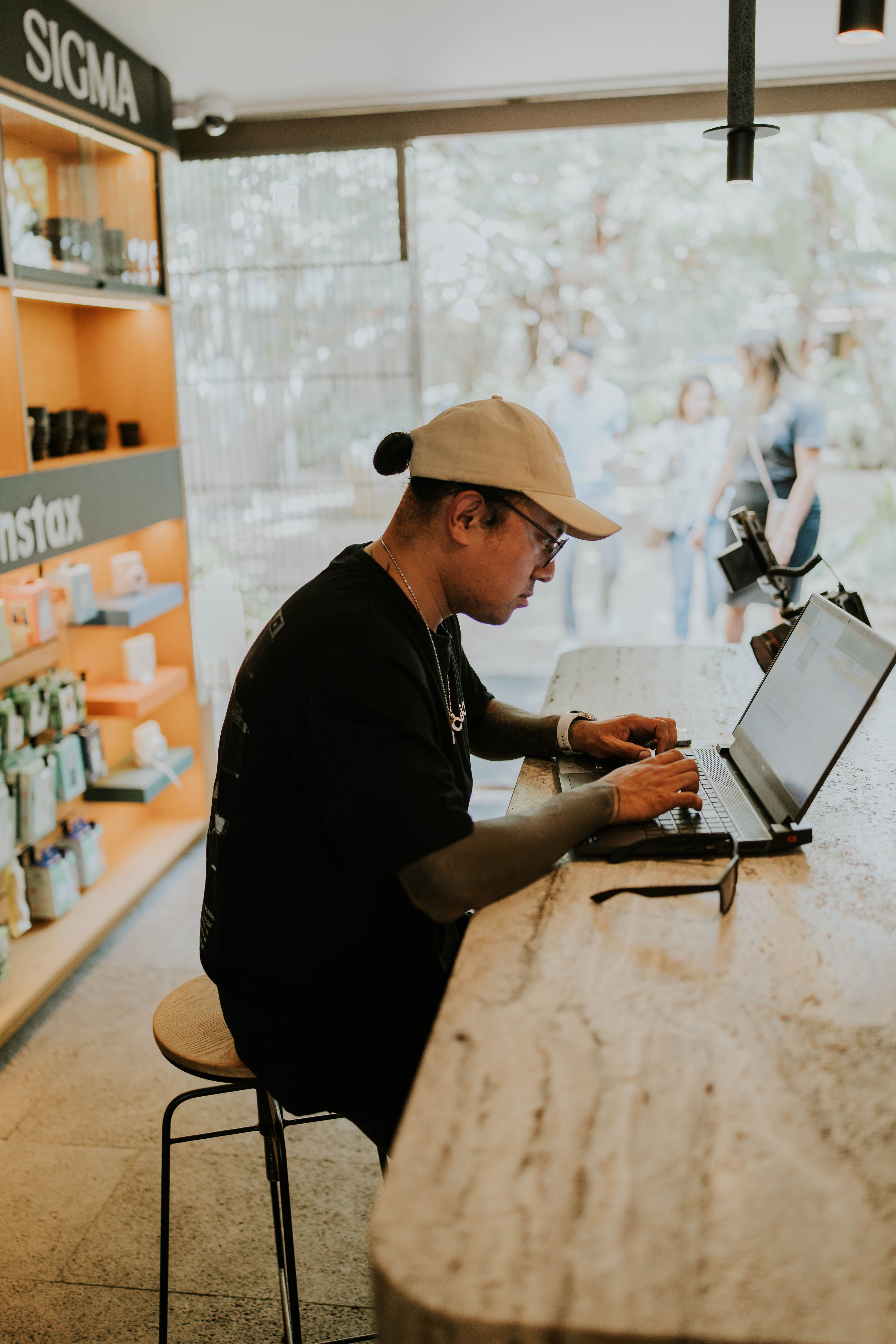 A person typing on a laptop, surrounded by travel photos and icons representing money and positive reviews