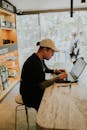 Man Working on Laptop in a Coffee Shop