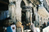 A vintage antique shop in a historic, sunny street setting. Charming and nostalgic.