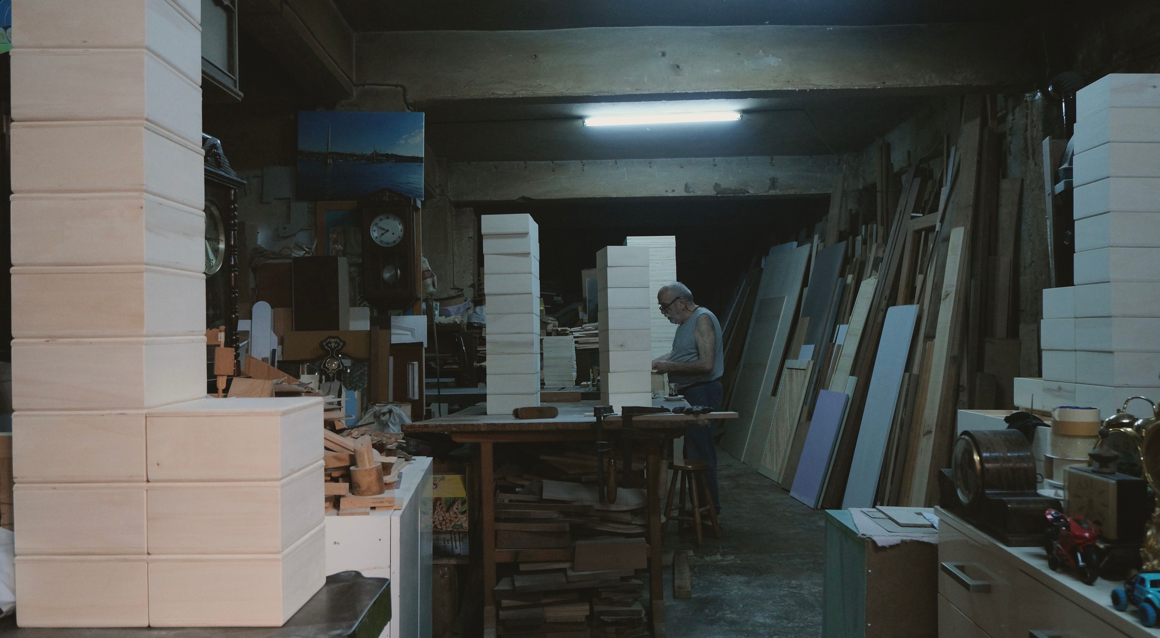 A skilled craftsman working on wooden creations in a rustic workshop. Tones of dedication.