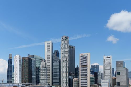 Free A vibrant cityscape of downtown Singapore with iconic skyscrapers under a clear blue sky. Stock Photo