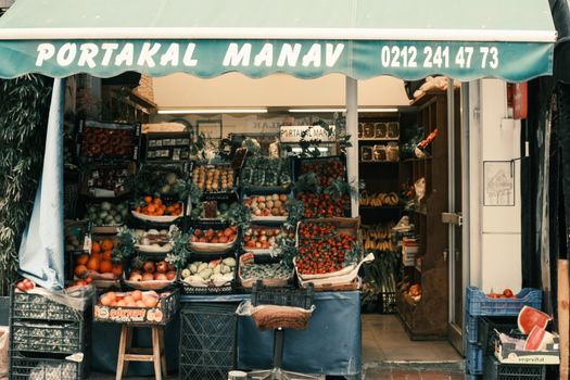 Colorful fruit and vegetable stall with canopy on a street market