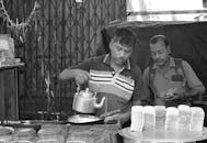 Street Vendor Serving Tea at Outdoor Market