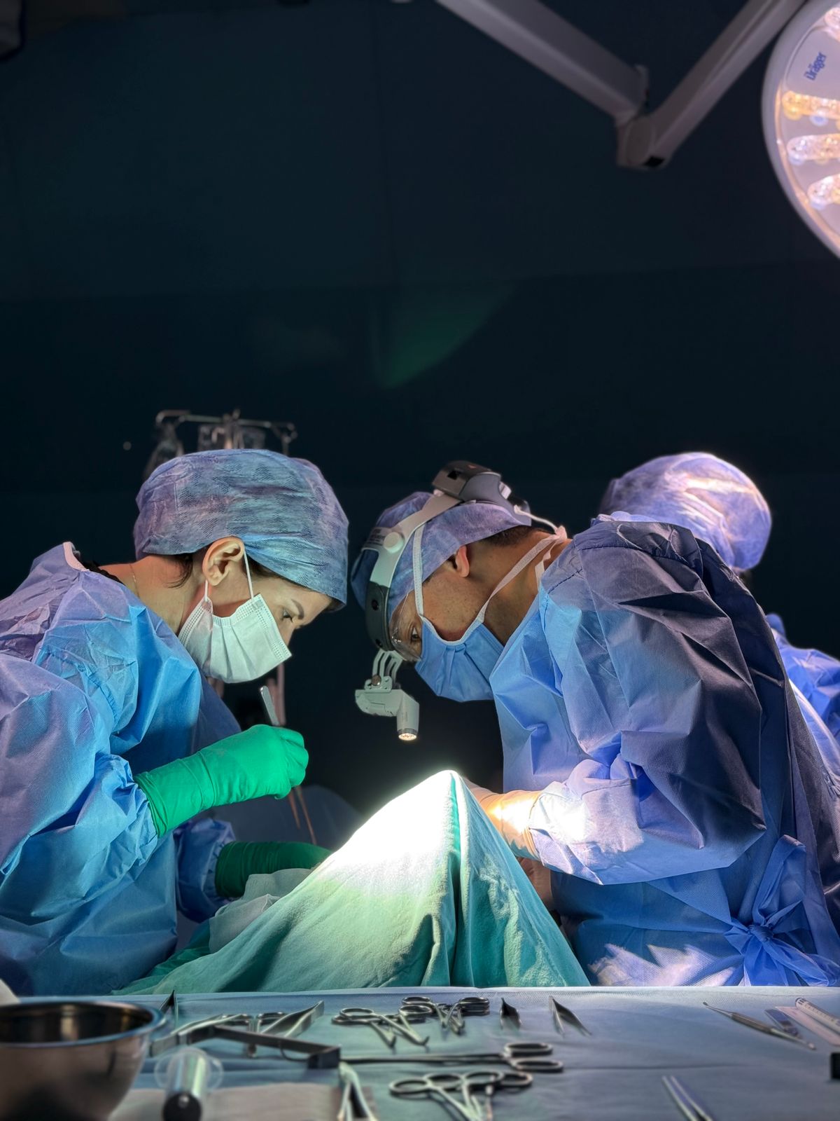 Surgical team performing an operation in a modern hospital operating room