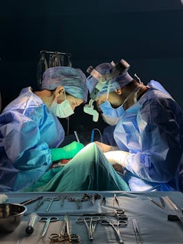 Two surgeons in a sterile operating room performing surgery with precision and focus.