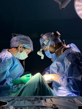 Two surgeons performing surgery in a well-equipped operating room, focused and precise.