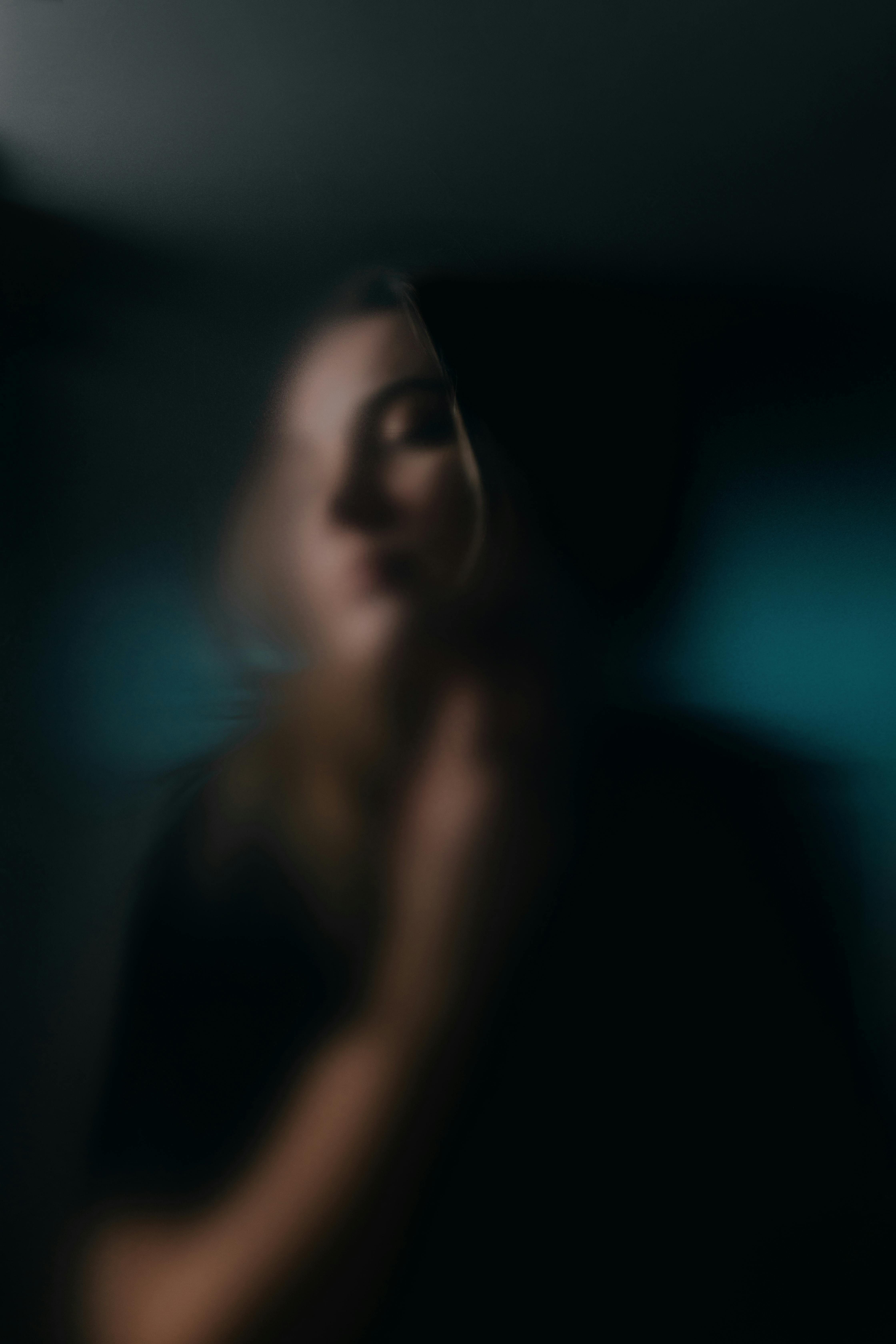 Artistic soft-focus portrait with a dreamy, blurred aesthetic, evoking mystery.