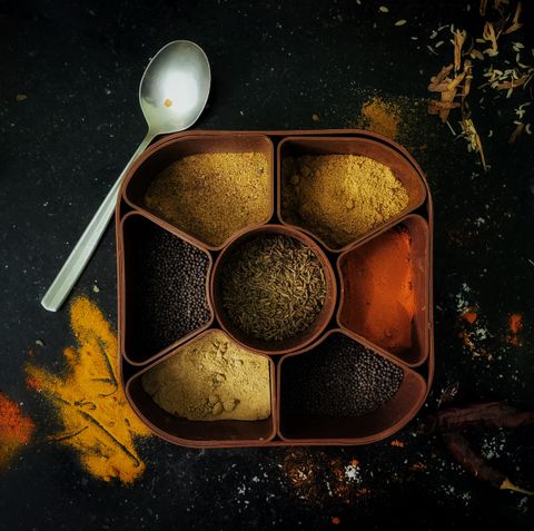Steel masala dabba filled with ground spices