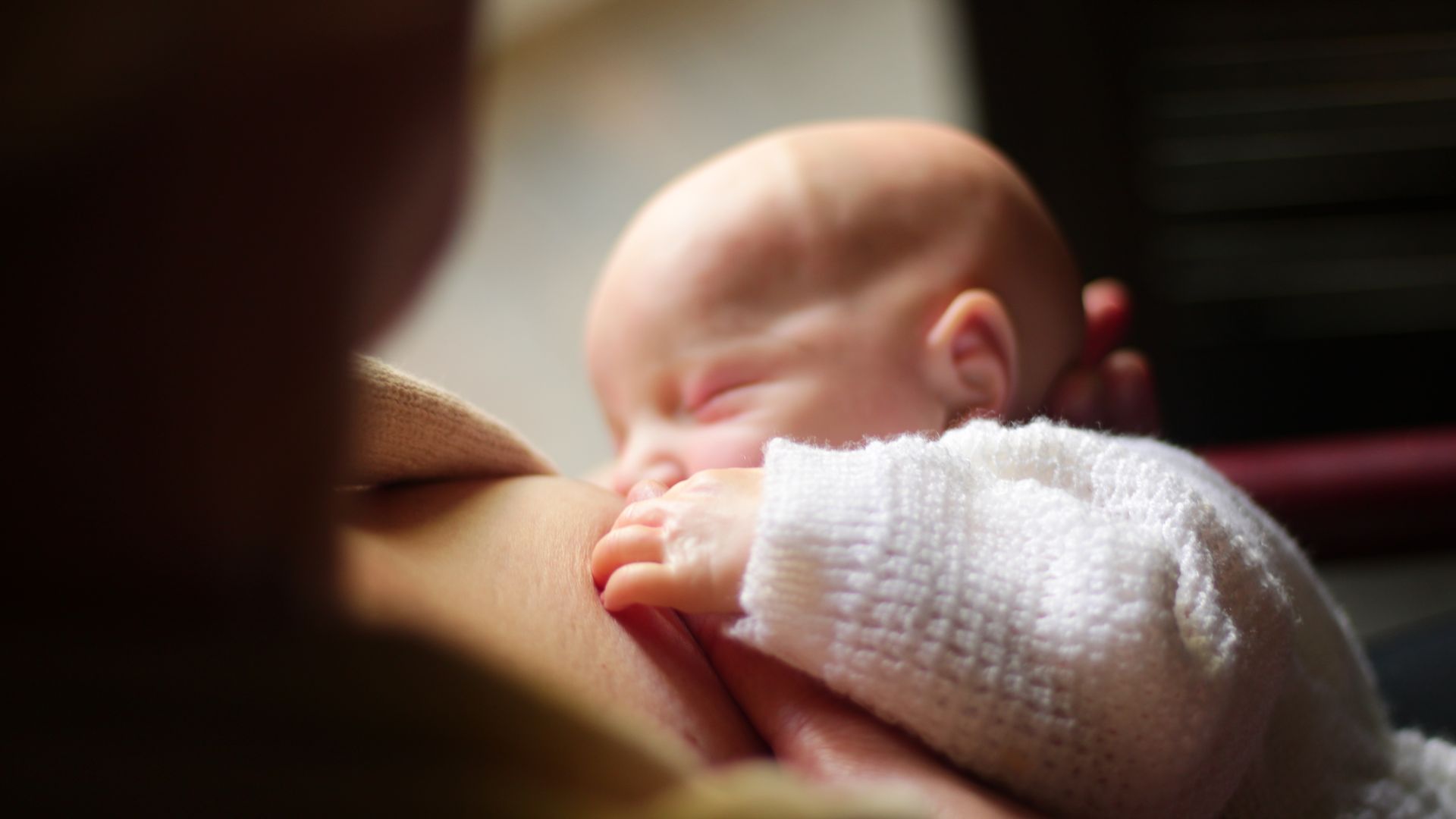 Modafinil for New Parents: Unlocking Energy and Focus A close-up view of a mother breastfeeding her newborn baby, capturing a tender and intimate moment — modafinil for new parents