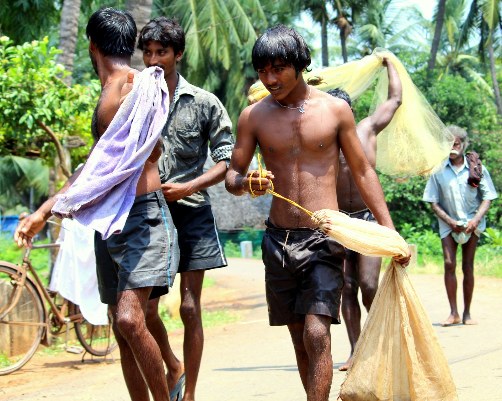 Fishermen preparing fishing nets in a village in India