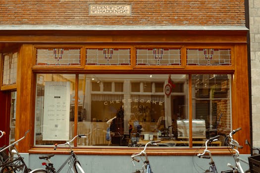 Explore the quaint charm of a cheesecake shop front in Amsterdam's historic streets.