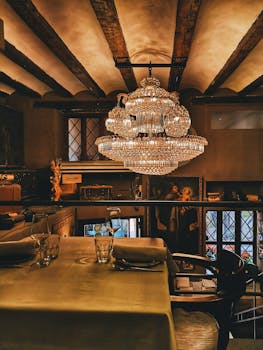 Cozy restaurant interior in Valencia featuring a stunning chandelier and classic decor.