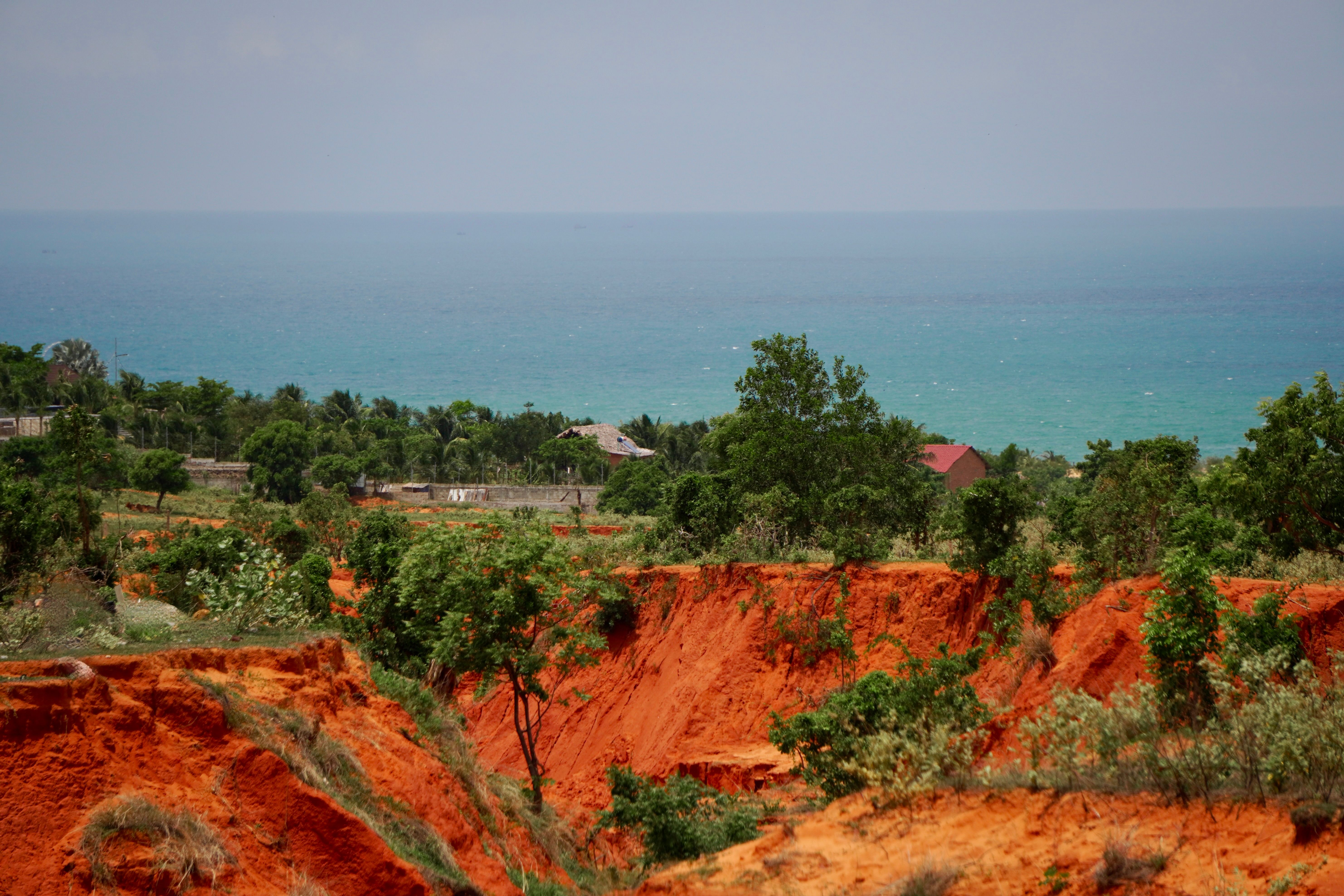 Red Cliffs Overlooking a Vibrant Sea Landscape · Free Stock Photo