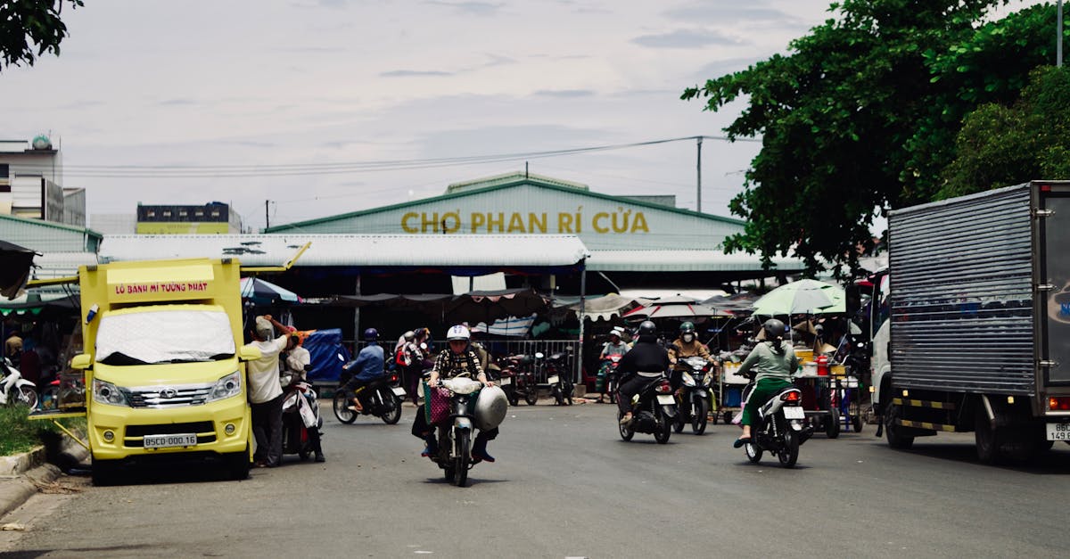 Motorbikes and vendors at Phan Ri Cua Market, flourishing with activity.