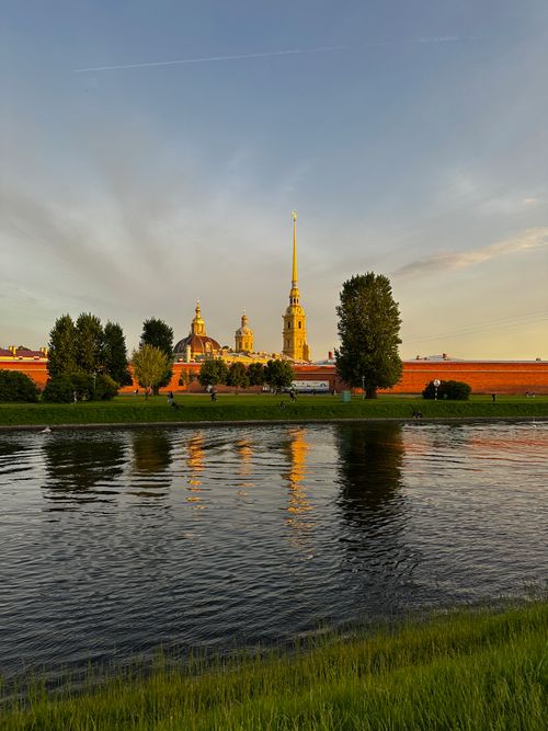 Free Captivating view of Peter and Paul Fortress in Saint Petersburg reflecting on the river at sunset. Stock Photo