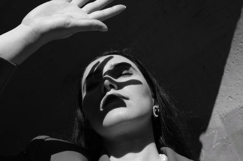 Free Artistic black and white portrait with dramatic shadows on a woman's face. Stock Photo