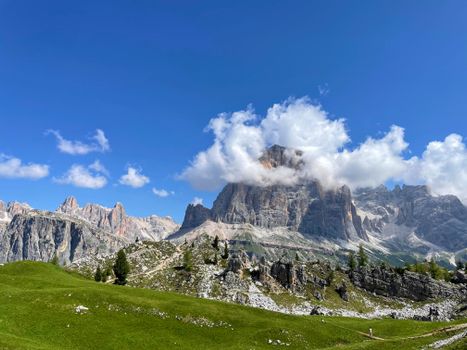 Explore the stunning mountain scenery of the Dolomites in Veneto, Italy under a clear blue sky.
