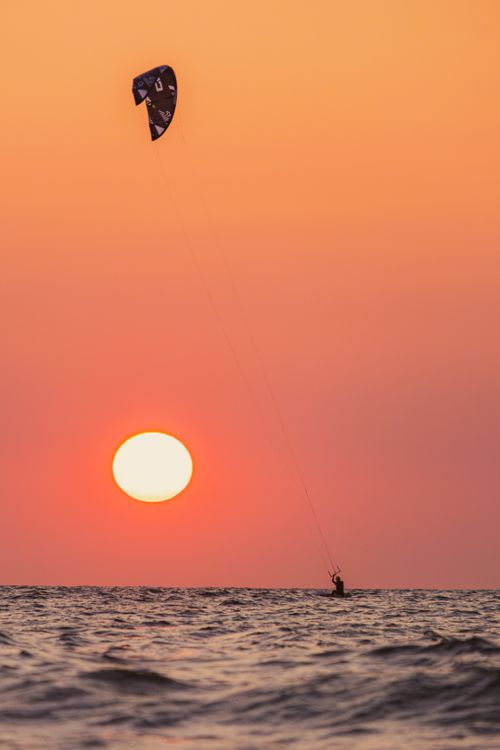 Free Kiteboarder at sunset over the beach in Middelkerke, Belgium. Stock Photo