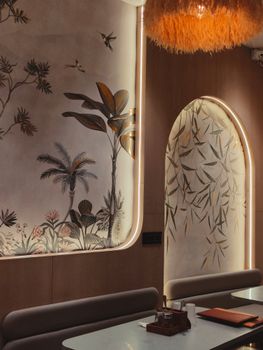 Chic restaurant interior with artistic wall decor and ambient lighting.