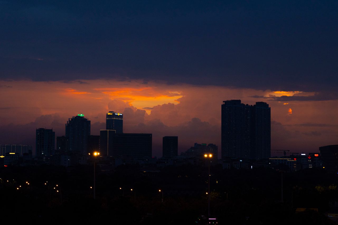 a city skyline silhouetted against a vibrant sunset creating a dramati