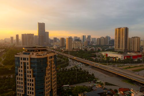 Free Aerial view of a bustling city at sunset with modern skyscrapers and highways. Stock Photo