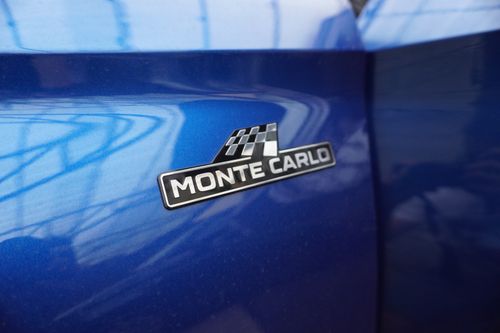 Free Close-up of Monte Carlo emblem on a glossy blue car surface, capturing sleek automotive detail. Stock Photo