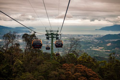 Free Aerial view of cable cars soaring over the lush landscape of Bana Khurd, offering a stunning vista. Stock Photo