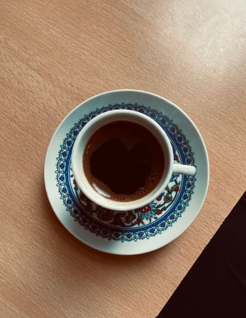 Free Top view of a beautifully crafted Turkish coffee cup with intricate designs on a wooden table. Stock Photo