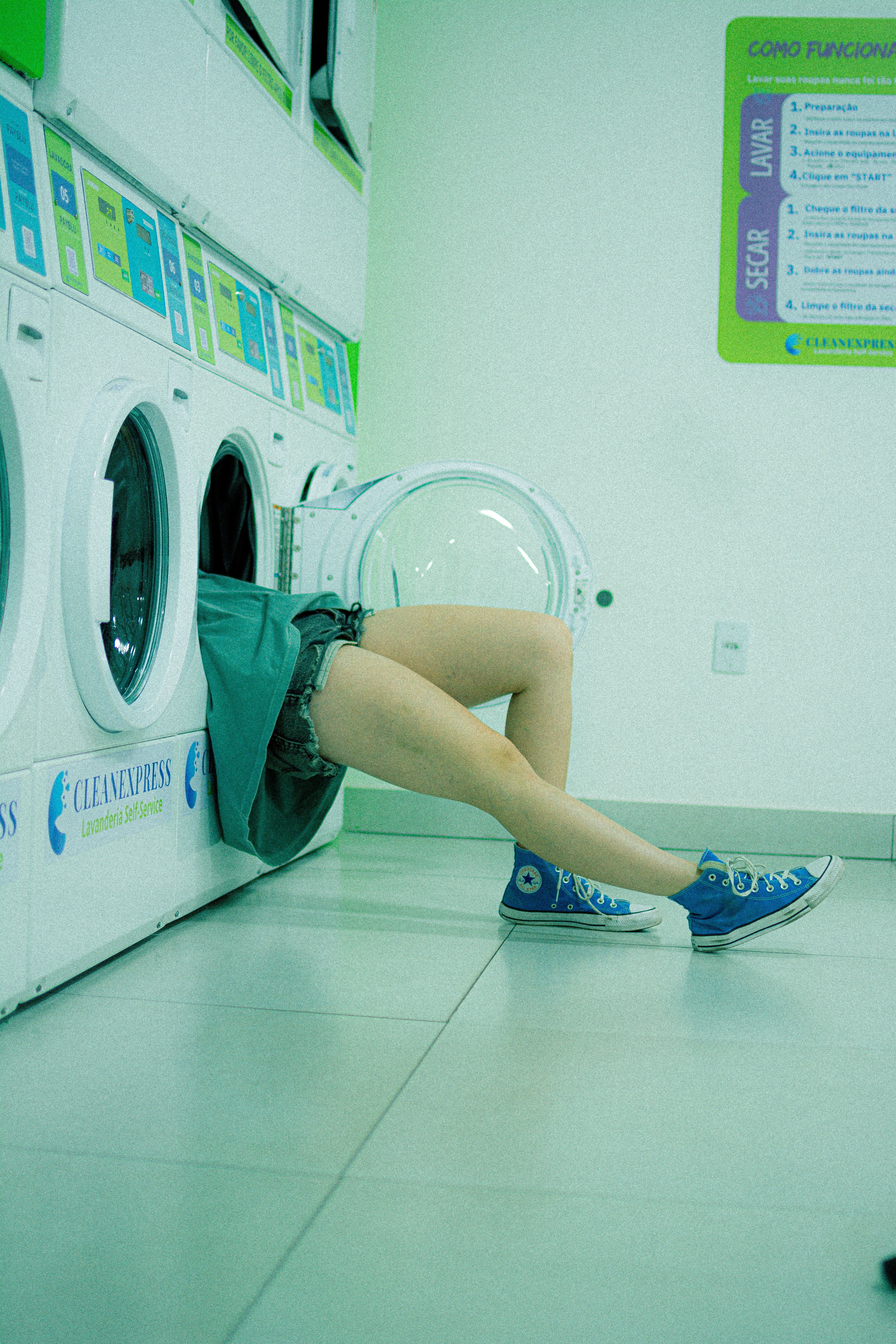 Person in Washing Machine at Laundromat · Free Stock Photo