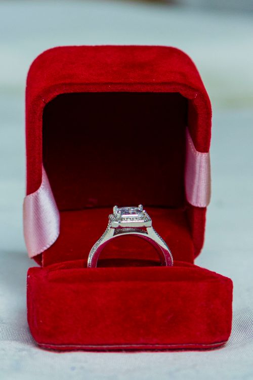 Free Close-up of a sparkling diamond ring housed in a luxurious red velvet box. Stock Photo