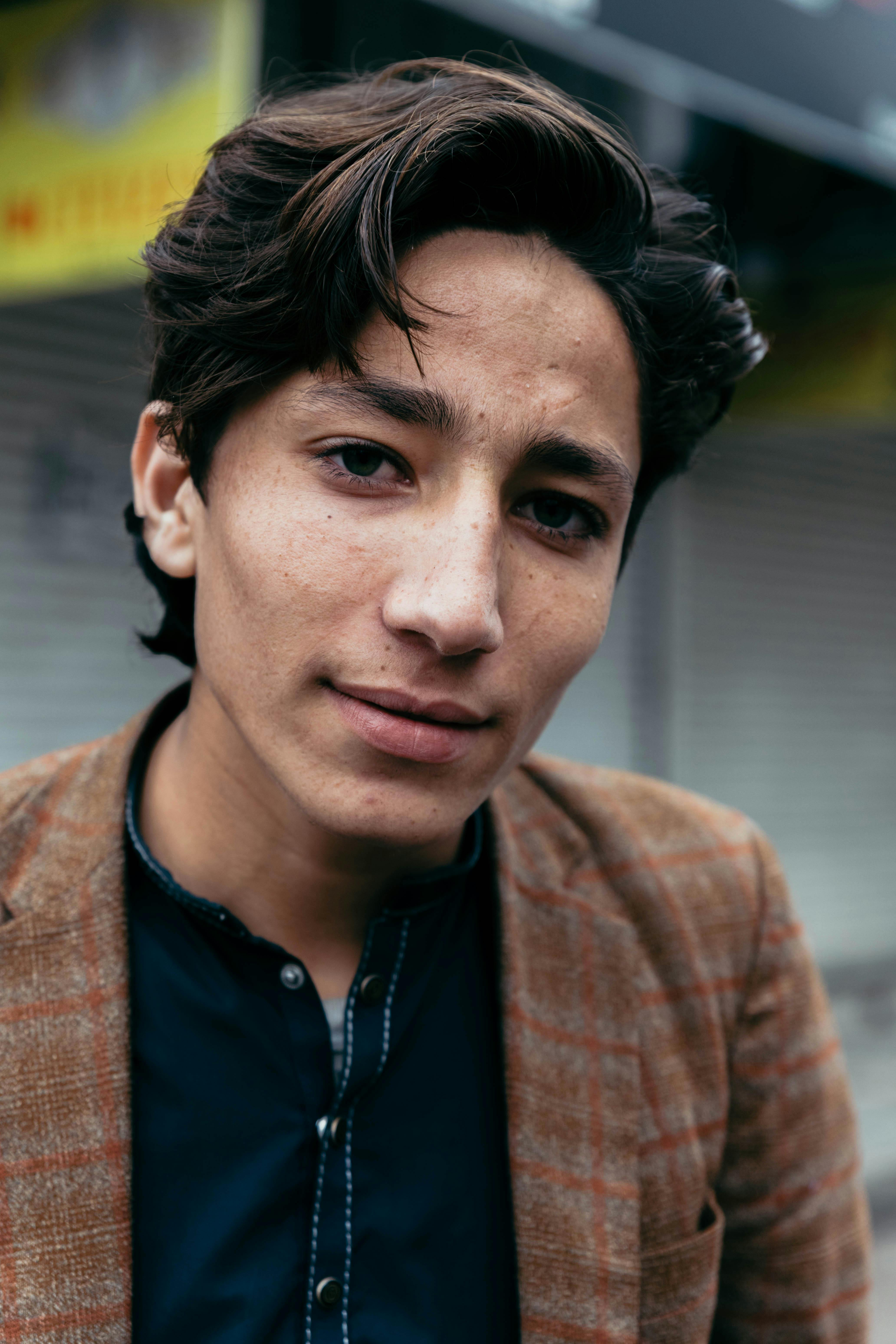 Portrait of a young man in a stylish jacket on a street in Faisalabad, Pakistan.
